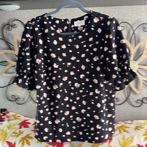 Cute women’s casual shirt with puffy sleeves. Pink flowers.
